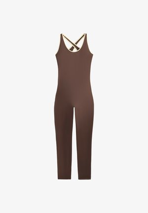 Brun ärmlös figursydd jumpsuit med krämfärgad kant och korsade band bak, ben i full längd.