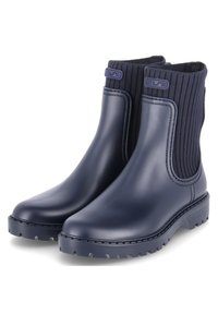 Botas de goma náuticas hasta el tobillo con parte superior de textil acanalado, punta redondeada y suela gruesa con un relieve profundo para mayor tracción. Detalle del logo en la parte superior.