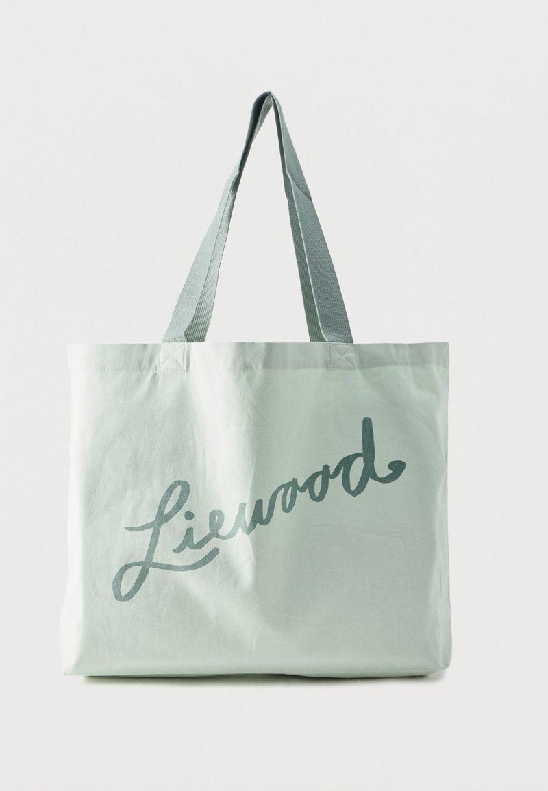 Λευκή τσάντα ώμου από καμβά με γκρι κείμενο "Liewood" και γκρι ιμάντες ώμου, εμφανιζόμενη σε απλό λευκό φόντο.