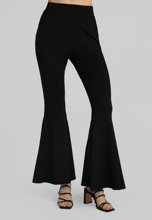 Madnezz House FLARED - Stoffhose - black
