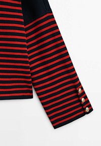 Navy and red striped sweater with ribbed texture. Features gold-button accents on the cuff. Cotton blend material, casual design.