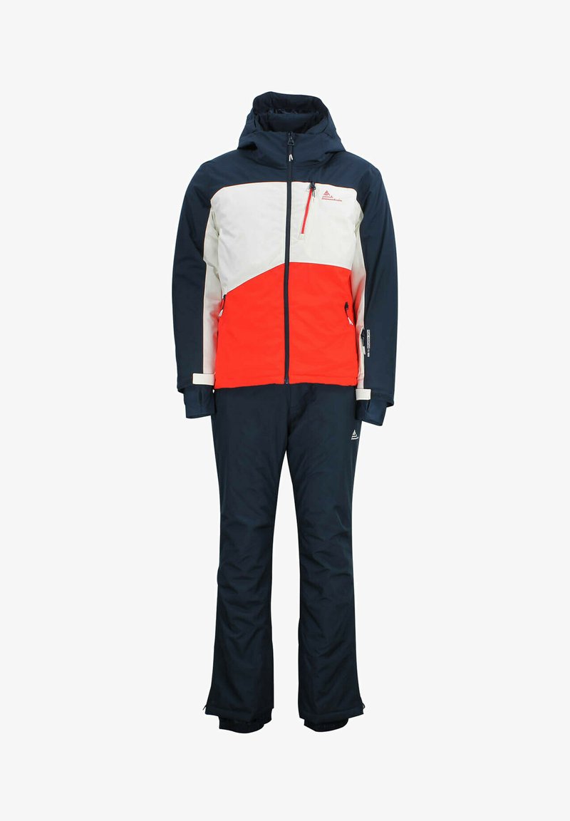 Combinaison de ski imperméable avec un design en blocs de couleurs : rouge, blanc et bleu marine. La veste possède une capuche, une poche Brust et des poignets élastiques ; le pantalon est coupé droit.
