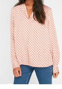 Blusa a maniche lunghe con sfondo rosa e pois arancioni, design a scollatura a V, tessuto morbido e vestibilità comoda.