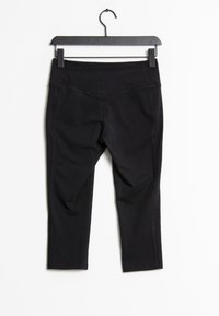 Svarta capri tights i elastiskt material med en mjuk yta, med en bred midja och inga synliga fickor. Hänger på en svart galge.