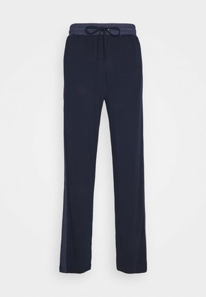 Navy blauwe relax-fit broek met een elastische tailleband en trekkoord, gemaakt van zachte stof, met zijslits voor comfort en beweging.