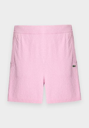 Rožinės frotinės šortai su elastinga juosmens juosta, su šoninėmis kišenėmis ir mažu žaliu logotipu ant kairės kojos. Tekstūruota medžiaga.