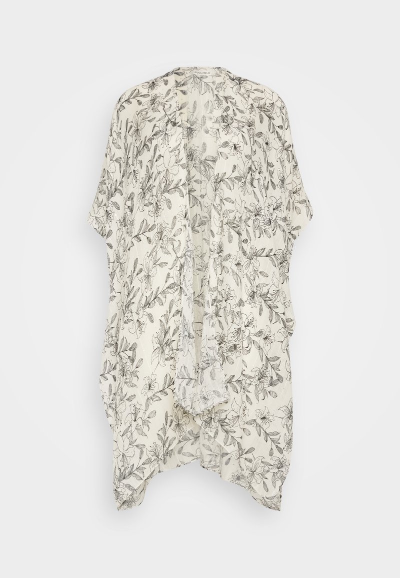 Lett kimono i kremfarge med svarte blomstermønstre. Har åpen front, løs passform og korte ermer. Myk, teksturert stoff.