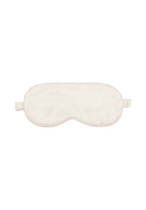 Masque de sommeil beige doux avec une bande élastique conçue pour couvrir les yeux afin de bloquer la lumière pendant le repos.