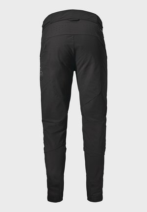 Black, slim-fit pants with a textured finish, featuring angled seams, perforations at the waistband, and subtle logo detail on the side.