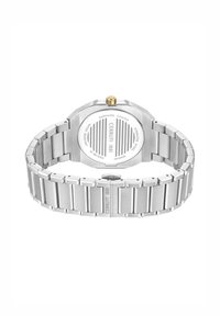 Reloj de acero inoxidable con caja octagonal pulida, acabado cepillado y corona en tono dorado. Cuenta con un fondo recubierto de zafiro blanco con detalles grabados.