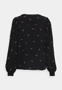 Blouse noire à longues manches bouffantes, ornée de petits motifs paisley roses. Tissu lisse et détails de boutons aux extrémités des manches.