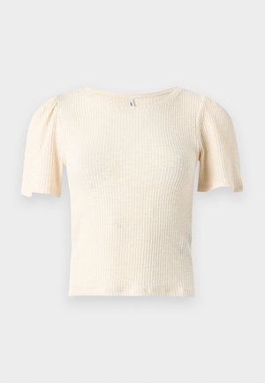 Kortermet, ribbestrikket topp i en lys beige farge. Myk tekstur med en tettsittende passform og lette puffermet, med en rund halslinning.