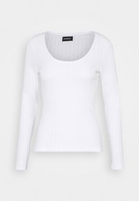 Witte lange mouw top met een ronde halslijn, gemaakt van ribbelstof. Bevat horizontale strepen en een aansluitende snit. Label leesbaar binnenin.