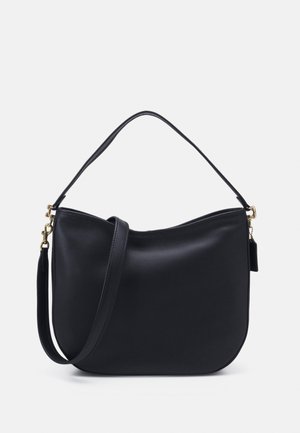 Černá kožená kabelka přes rameno s kulatým tvarem, zlatými kovovými doplňky a jedním popruhem. Hladký povrch s minimalistickým designem.