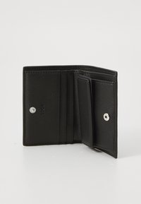 Black leather wallet with a textured finish, featuring multiple card slots, a compartment for cash, and silver snap fastening.