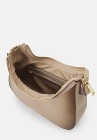 Beige leather bag with a smooth finish, featuring a gold zipper and hardware, and a lined interior with a smaller zipped pocket.