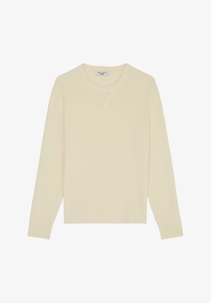 Pull en maille à manches longues de couleur crème avec texture côtelée et col rond, présentant un petit détail en V cousu sous le col.