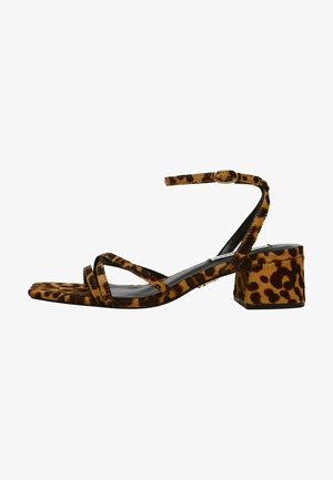 Leopard-patterned high-heeled sandal made of soft fabric. Features narrow straps, a square toe, and a chunky heel with a textured finish.