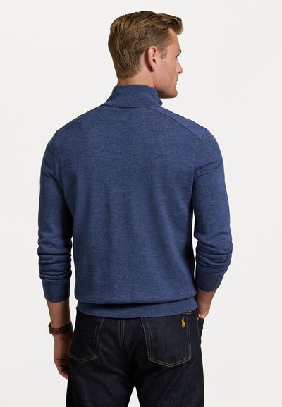 Navy blue knit sweater with a high collar and textured finish. Features contrasting shoulders and ribbed cuffs and hem. Casual fit.