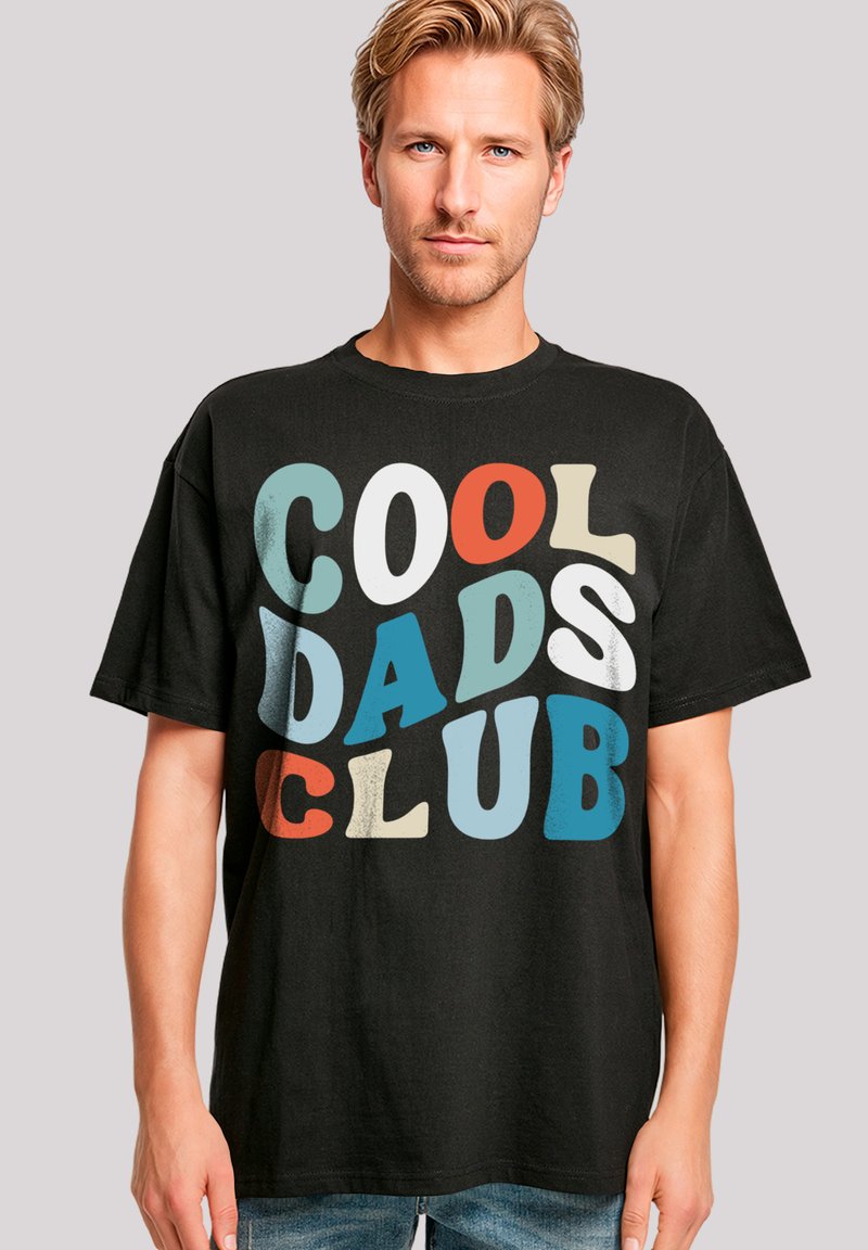 Black cotton t-shirt featuring "COOL DADS CLUB" text in various colors and bold fonts, short sleeves, and a crew neckline.