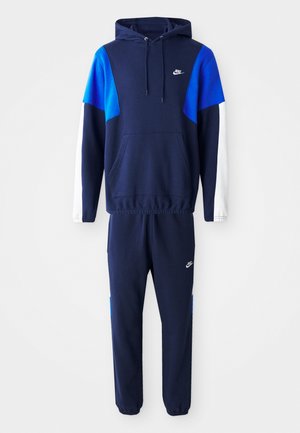 Navy blue tracksuit consisting of a hooded sweatshirt with blue and white accents and tapered pants, featuring a front pocket and logo detail.