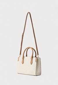 Μπεζ τσάντα χειρός με ανάγλυφο μοτίβο λογότυπου, καφέ δερμάτινες λαβές, ρυθμιζόμενο λουράκι ώμου και χρυσές μεταλλικές λεπτομέρειες.