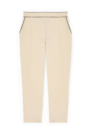 Beige skråbukser med sidelommer og sort pipingdetalje langs linningen og lommekanter.