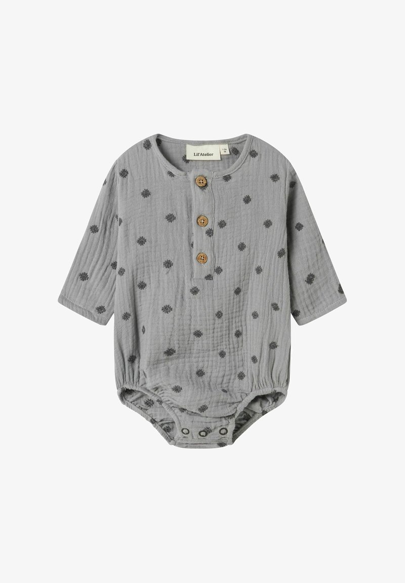 Siv kulski bodi z dolgimi rokavi, ki ima majhne črne pike in tri lesene gumbi na ovratniku. Zapiranje s pritisnimi gumbi na dnu.