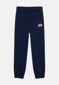 Navy blue sweatpants made of soft fabric, featuring an elastic waistband with drawstrings and a pink "GAP" logo on the left thigh.