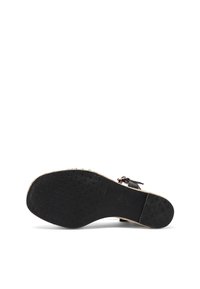 Sole di sandalo nera con grip in gomma testurizzata, forma arrotondata e bordo in un contrastante color beige chiaro. Accento della fibbia per una vestibilità regolabile.