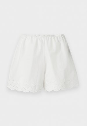 Λευκά βαμβακερά σορτς με ελαστική μέση και κυματιστό τελείωμα με κεντητά λουλουδένια σχέδια με κοψίματα.