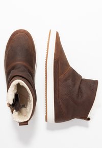 Brown leather ankle boots with white rubber soles, soft fleece lining, and a textured finish. Features a side zipper and low-profile design.