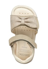 Infradito beige con un fiocco scintillante, materiale superiore morbido, soletta perforata per traspirabilità e cinturino regolabile per una vestibilità sicura.