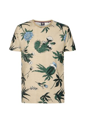 Maglietta beige in cotone a maniche corte con una stampa botanica colorata che presenta cactus verdi, fiori blu e bianchi e foglie verde scuro.