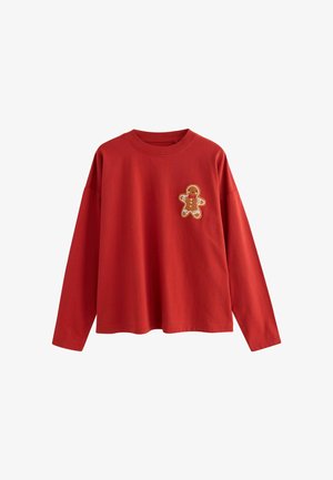 Red long-sleeve t-shirt made of cotton, featuring a gingerbread man applique on the left chest. Relaxed fit with a round neckline.