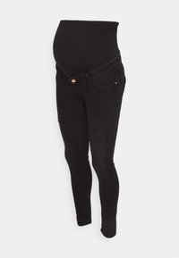 Svarta graviditetsjeans med en elastisk midjeband som går över magen, slim fit och slitna detaljer på benen. Tillverkade av denimtyg.
