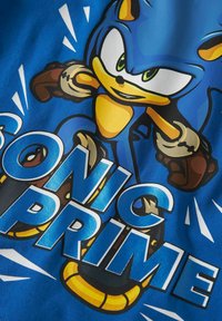 Blue t-shirt featuring a graphic of a stylized anthropomorphic character. Text reads "SONIC PRIME" in bold, white letters with yellow accents.