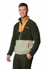 Fleece jacket in dark green, featuring an orange collar, gray lower panel, and two zippered pockets with orange pulls. Columbia logo visible.
