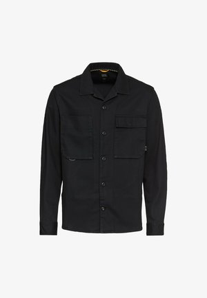Zwarte longsleeve shirt gemaakt van geweven stof, met een kraaghals, twee borstzakken, knoopsluiting en een rechte zoom.