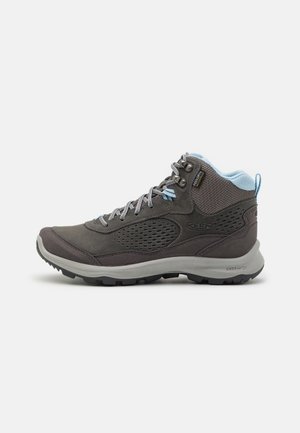 High-top hiking boot in dark gray with light blue padded collar, mesh panels, gray laces, and thick textured sole for traction.