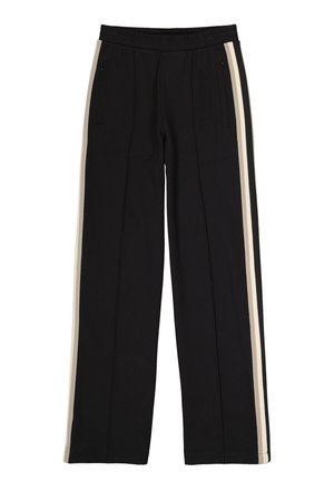 Pantalons noirs avec une taille élastique, dotés de deux bandes verticales crème sur les côtés et de poches zippées à l'avant.