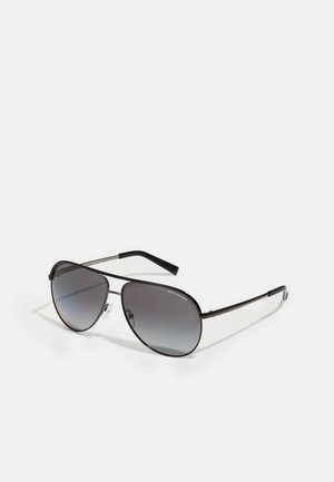 Aviator sunglasses with dark gradient lenses, thin metal frame, and black plastic temples. Includes nose pads for comfort.