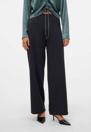 Black wide-leg pants with a smooth texture, paired with a blue-green blouse featuring a gathered design and drawstring detail.