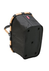 Schwarze Stofflagerungstasche mit einem stabilen, beige-farbenen Rahmen, runder Form und mehreren Füßen für Stabilität. Verfügt über seitliche Tragegurte und ein kleines Logo.