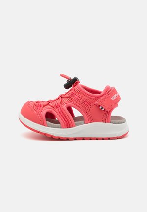 Bright pink children's sandal with open design, textured upper, adjustable strap, and cushioned insole. Lightweight rubber sole.