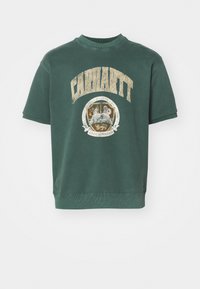Zelená mikina s krátkým rukávem z bavlněné směsi s velkým logem Carhartt a kulatým grafick�ým emblémem na přední straně. Měkká, texturovaná tkanina.