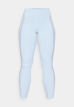 Light blue leggings featuring a high waistband, smooth texture, and contrast stitching along the sides. Full-length design.