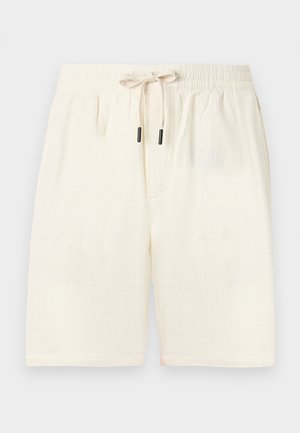Cream-colored shorts made of textured fabric with a check pattern. Features an elastic waistband with a drawstring and two side pockets.