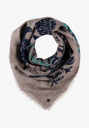 Écharpe marron clair avec bords à franges, présentant des motifs floraux abstraits en bleu foncé et bleu sarcelle, pliée en forme circulaire.