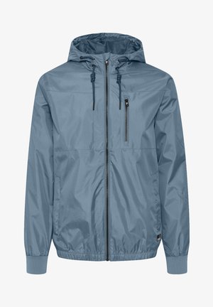 Hele sinine tuulejope kapuutsiga. Valmistatud kergest, veekindlast materjalist. Omab lukuga taskut ja elastseid mansette.